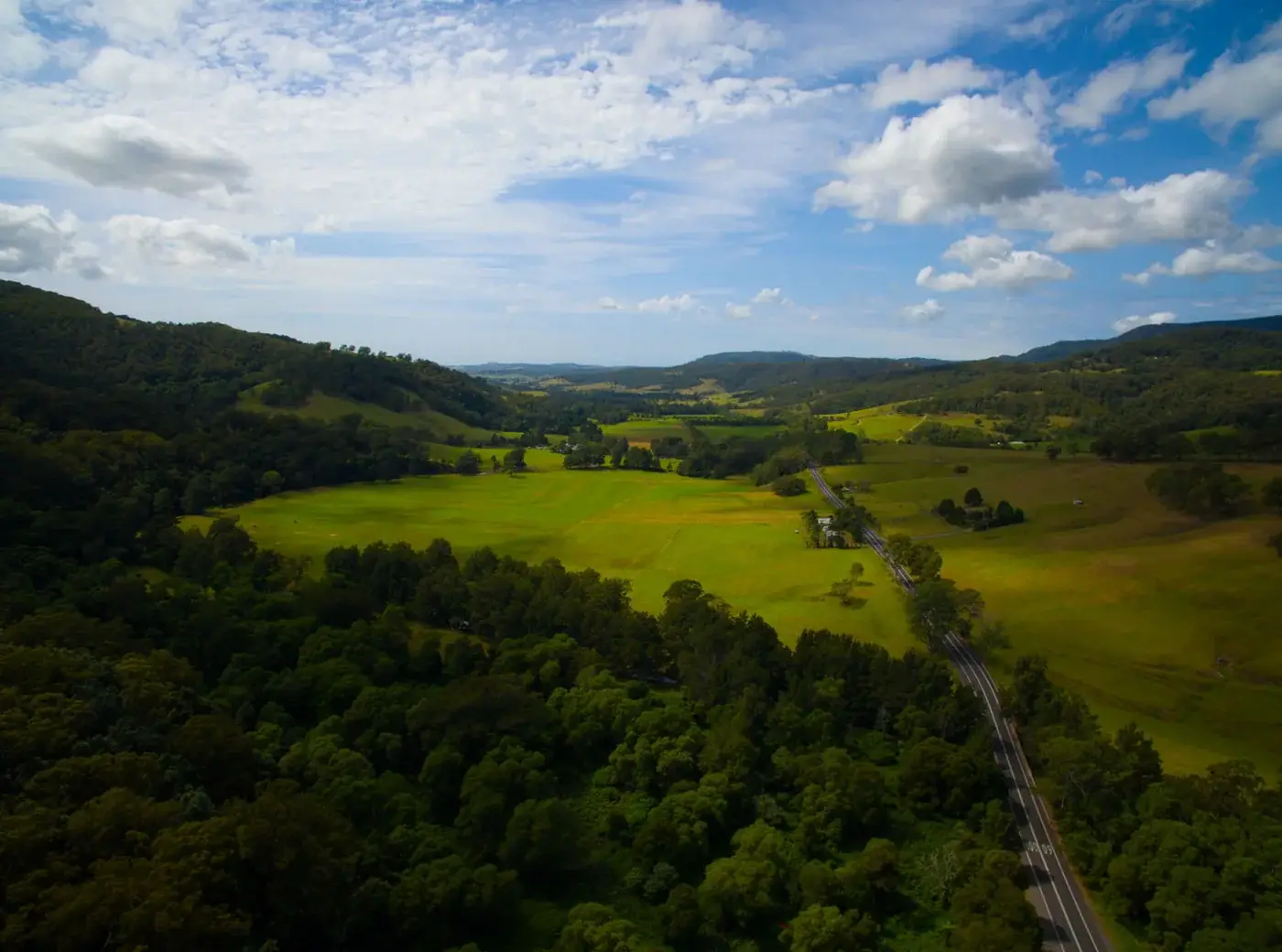 Aerial view of green farmland and escarpment in the Illawarra