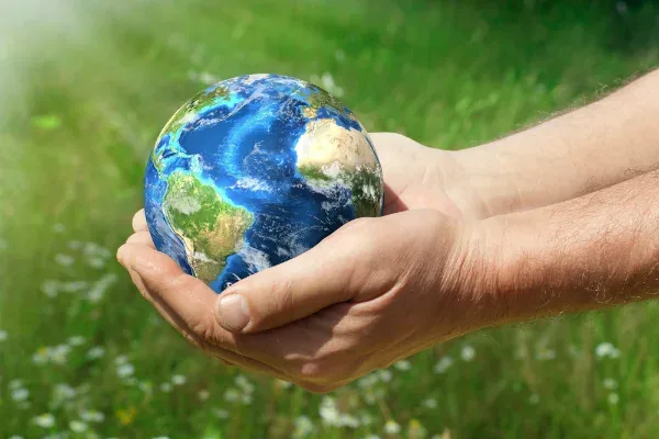 Hands cradling a globe, illustrating extended producer responsibility