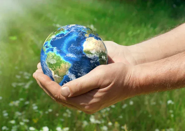Hands cradling a globe, illustrating extended producer responsibility
